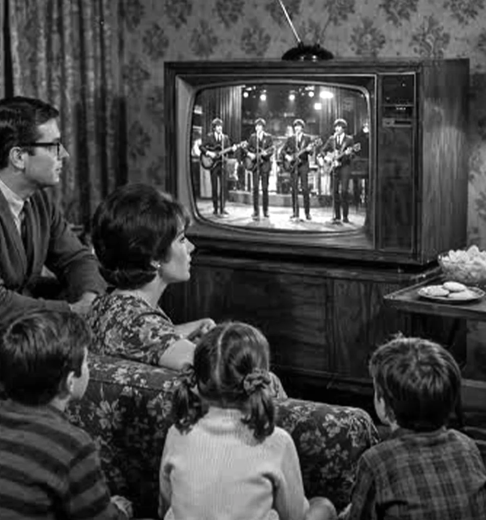 A 1960s family gathers around the television to watch the Beatles